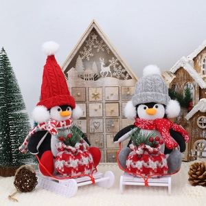 Christmas penguin gnome figurines with knit hats and scarves on white sledges decor