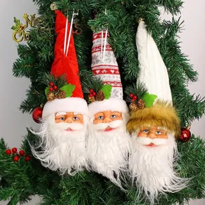 Set of 3 Santa Claus head ornaments with knit hats and pine cones on a Christmas tree