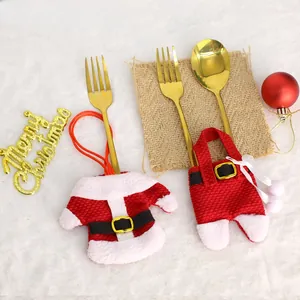 Christmas silverware holders with festive red Santa suit and pants on white fur