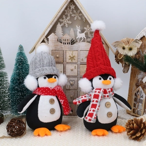 Pair of Christmas penguin gnome plush dolls wearing knitted hats and scarves for festive decor
