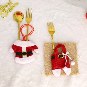 Christmas silverware holder with Santa jacket and pants set on white plush background
