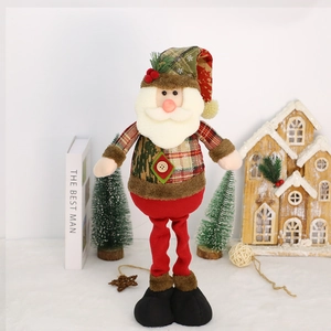 Detail of plush Christmas Santa doll with plaid clothes and berries for festive decoration