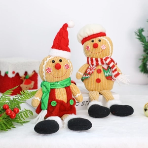Pair of knitted gingerbread man plush dolls with chef hats for Christmas party decorations