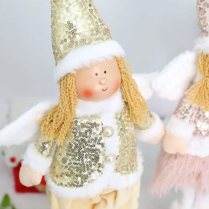 Close-up of plush Christmas angel doll with gold sequins, faux fur and pearl buttons