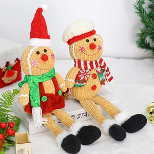 Pair of plush gingerbread dolls with chef hats and scarves for Christmas party decor