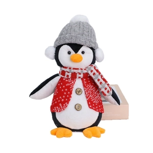 Christmas plush penguin toy wearing red knit sweater and festive hat for holiday decor