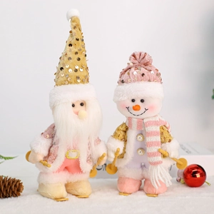 Detail of plush Christmas gnomes with pink sequins and wooden skis on a snowy fur surface