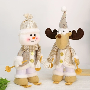 Detail of Christmas ski dolls set featuring snowman and reindeer in gold sequined outfits