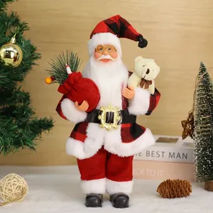 Standing Santa Claus figure in red plaid outfit with teddy bear and gift bag