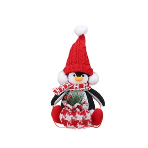 Christmas penguin plush doll in red knit hat holding a gift bag for holiday decoration