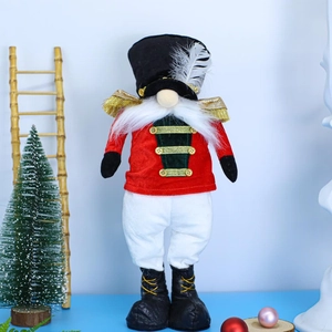 Close-up of a festive Christmas Nutcracker Gnome with a red suit and feather hat decoration