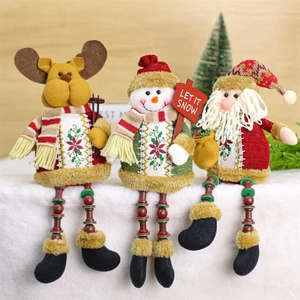 Detailed view of sitting plush Christmas figurines with beaded legs and Let It Snow sign
