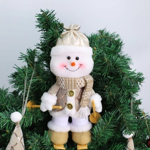 Close-up of plush snowman doll in gold sequin jacket on a green Christmas tree