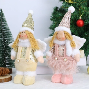 Detail of plush Christmas angel dolls with sequined hats and delicate feather wings