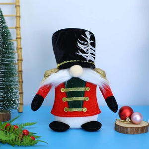 Detail of a Christmas gnome plush in nutcracker uniform with a white beard and feather hat