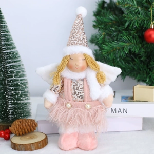 Detail of a Christmas angel doll wearing a pink sequin dress and white fluffy wings
