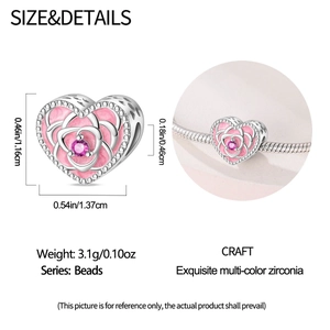 Macro shot of silver heart charm with pink enamel rose and zirconia on a bracelet