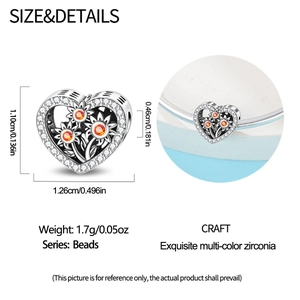 Detail of silver heart charm with sunflower design and orange zircon on a bracelet