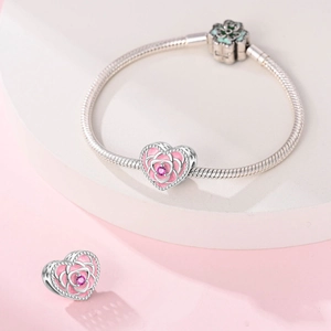 Silver snake chain bracelet with pink heart rose charm and green floral clasp detail