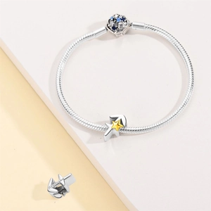 Detail of silver Sagittarius charm with engraved text and blue cubic zirconia on bracelet