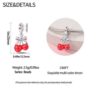 Detail of red cherry pendant bead in silver with green zircon on a snake chain bracelet