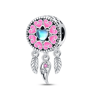 Macro detail of silver dreamcatcher charm with blue gemstone and pink enamel hearts