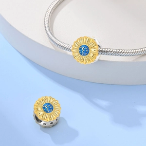 Macro view of sunflower bead with gold petals and blue starry sky enamel detail