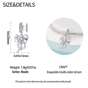 Detailed view of pink bow charm bead with heart zircon showing size measurements