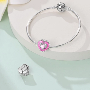 Detail of silver heart charm with Sweet Dream engraving and pink gemstone bead
