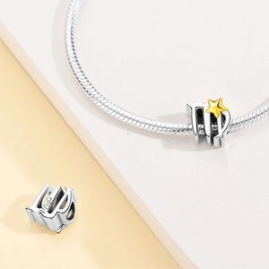 Detailed view of Virgo zodiac charm bead in silver with gold star accents for DIY jewelry