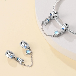 Silver space charms with rocket pendant and blue zircons on snake chain bracelet