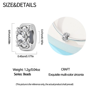 Macro detail of silver bead charm with intricate hollow patterns and cubic zirconia stones