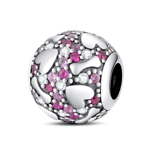 Detailed view of spherical charm with pink zircon pavé and silver heart motifs