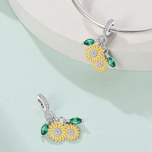 Detailed close-up of sunflower charm with yellow petals and green zircon leaves