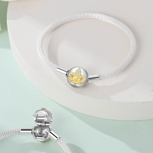Macro detail of S925 mesh bracelet with crown-engraved clasp and sparkling zirconias