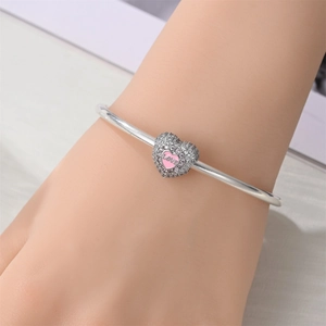Silver charm bracelet with a heart-shaped dangle pendant featuring pink LOVE enamel