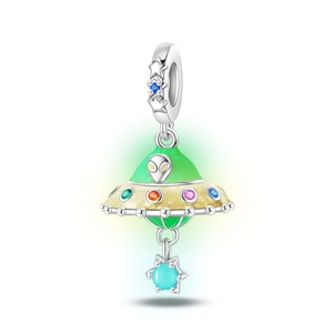 Macro view of UFO charm bead with green enamel and multicolor zircons for DIY jewelry