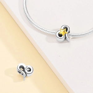Detailed macro view of silver Leo zodiac charm with gold star inlay on snake chain