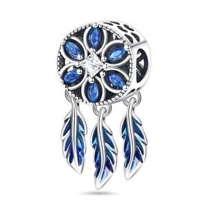 Macro shot of silver dreamcatcher charm with blue stones and three gradient feathers