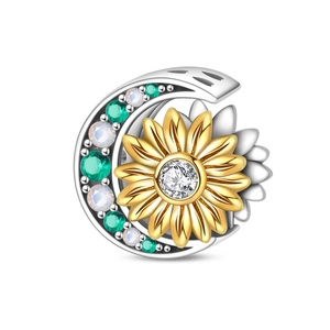 Macro shot of silver crescent moon and golden sunflower charm with colorful gemstones