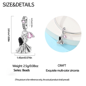 Detailed charm showing dancing couple in silver with pink heart zircon and black enamel