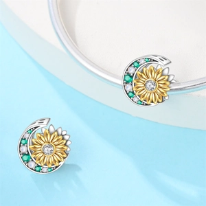 Detailed view of silver sunflower and moon charm pendant with embedded zirconia and gems