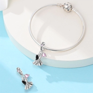 Detail of silver couple charm with pink heart zircon on snake chain bracelet