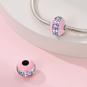 Pink enamel charm bead with sparkling crystals on a silver snake chain bracelet
