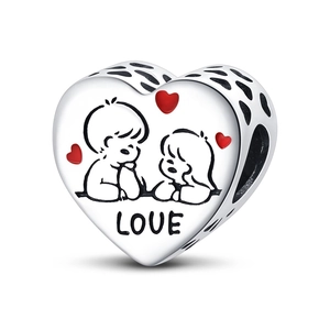 Macro-opname van zilveren hartbedel met jongen meisje motief, rode hartjes en LOVE-gravure