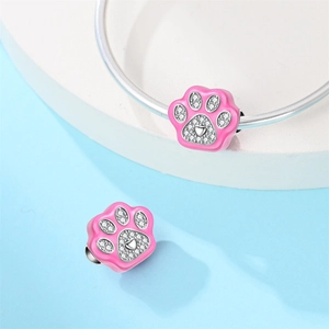 Pink enamel pet paw charm with white zircon heart detail on silver charm bracelet
