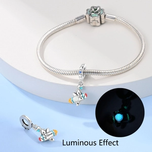 Luminous astronaut rocket charm on silver snake chain bracelet with glow effect