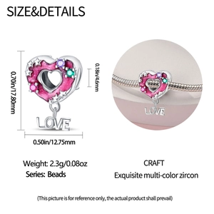 Macro view of heart-shaped silver charm with pink enamel glitter and LOVE tag detailing
