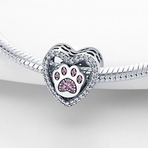 Macro view of heart-shaped cat paw charm with pink and white zirconia on snake chain