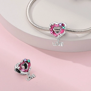 Pink enamel heart charm with glitter and LOVE pendant on silver snake chain bracelet
